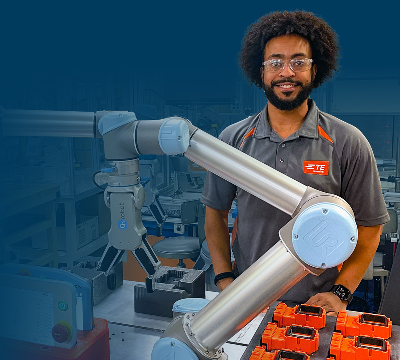 Kellen Haile next to robotic arm