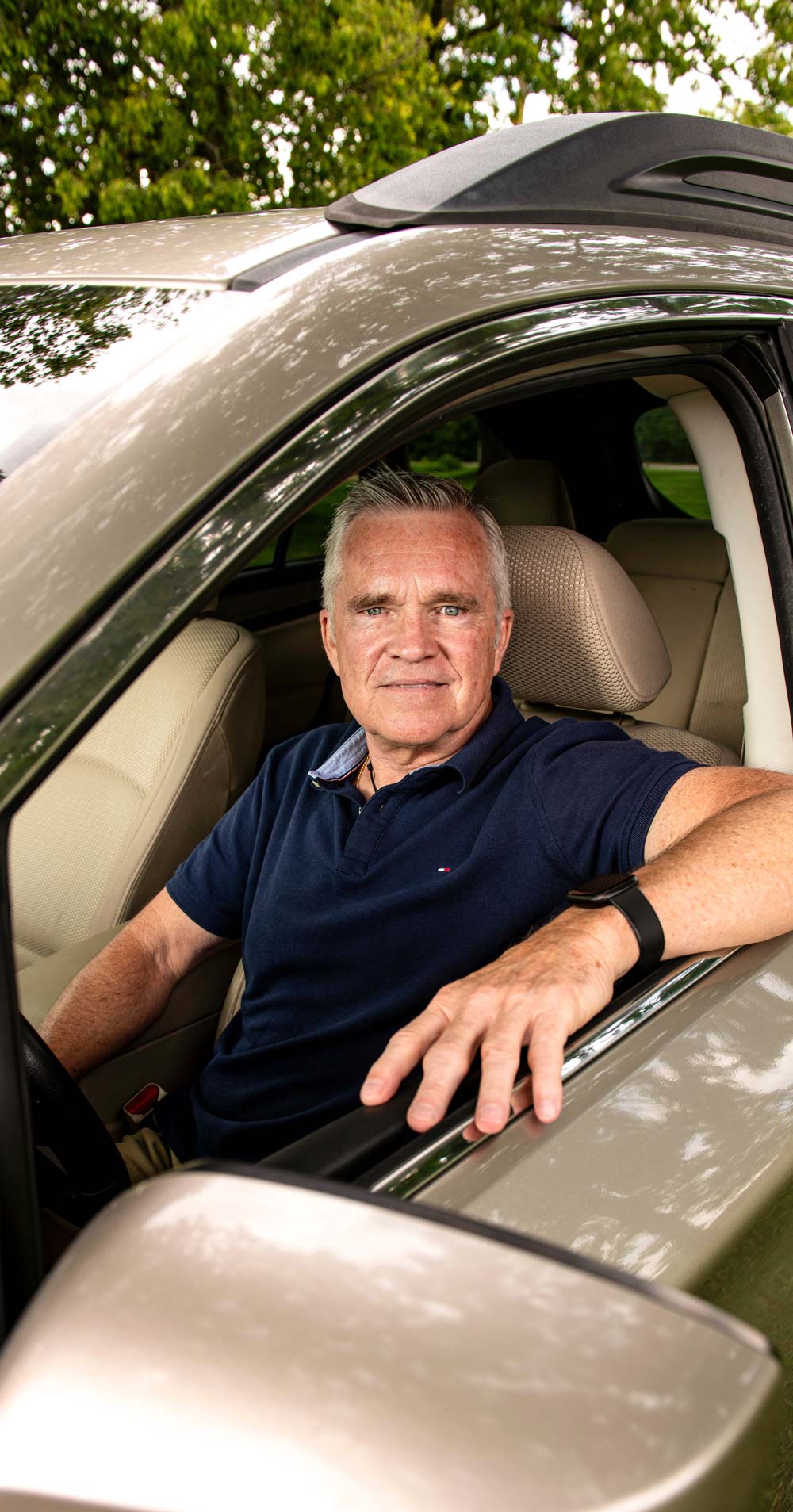 Kevin Fitzgerald sitting in the driver seat of a car