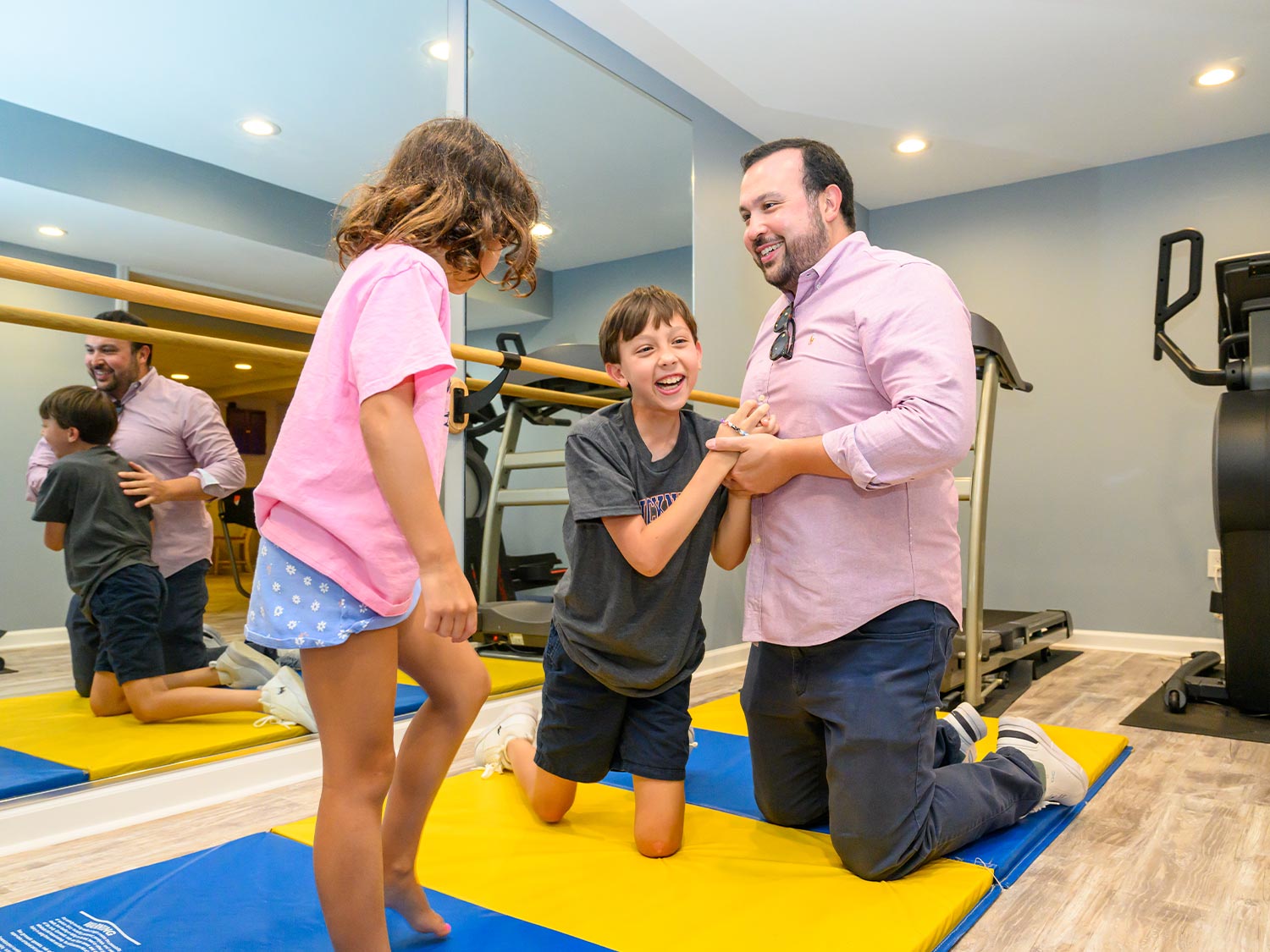 Preston and Lucy enjoying gym time with their dad, Peter Gale in the Agostini family’s home gym