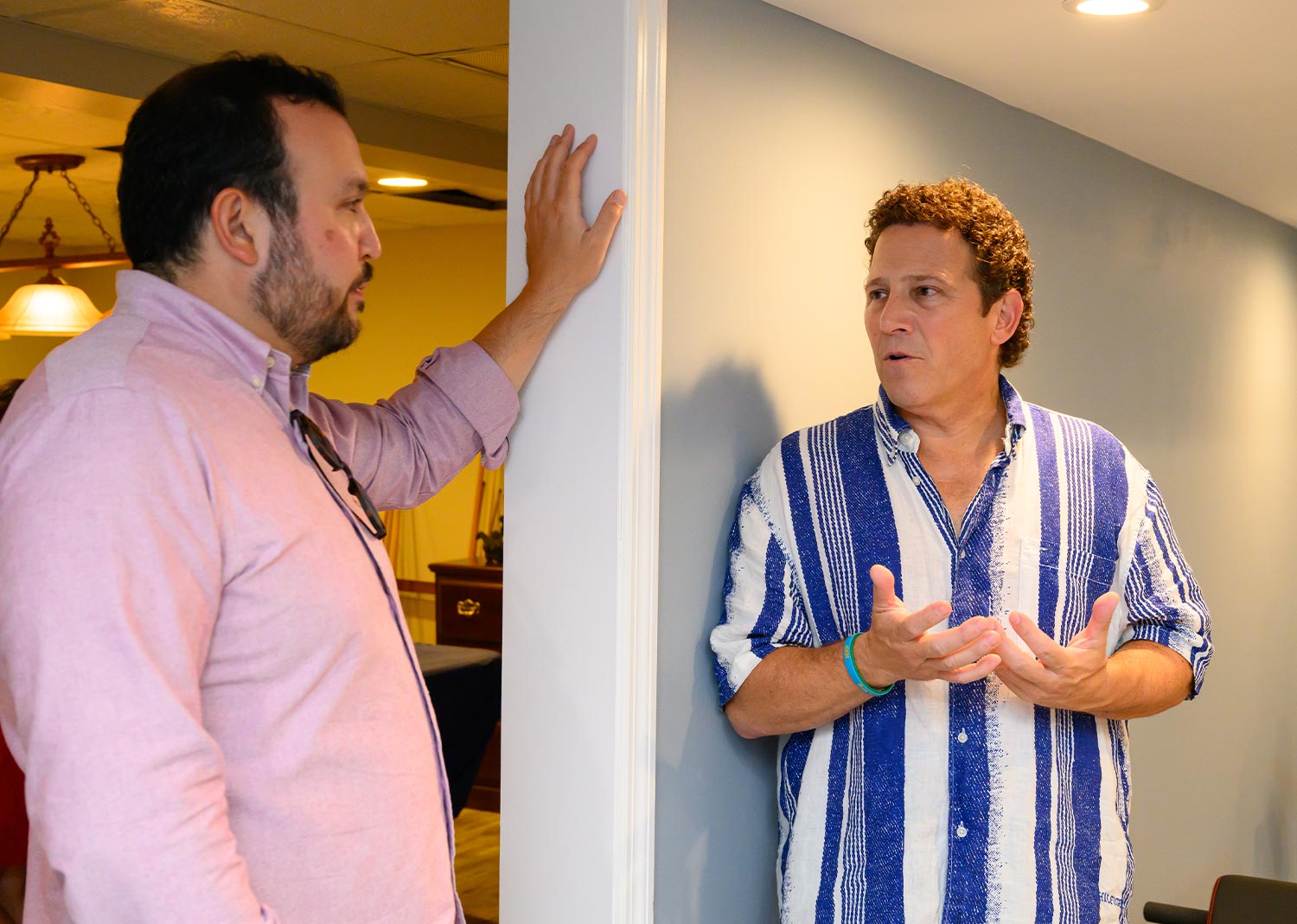 Peter Gale and Peter Agostini pictured talking while standing in a hallway at the Agostini home