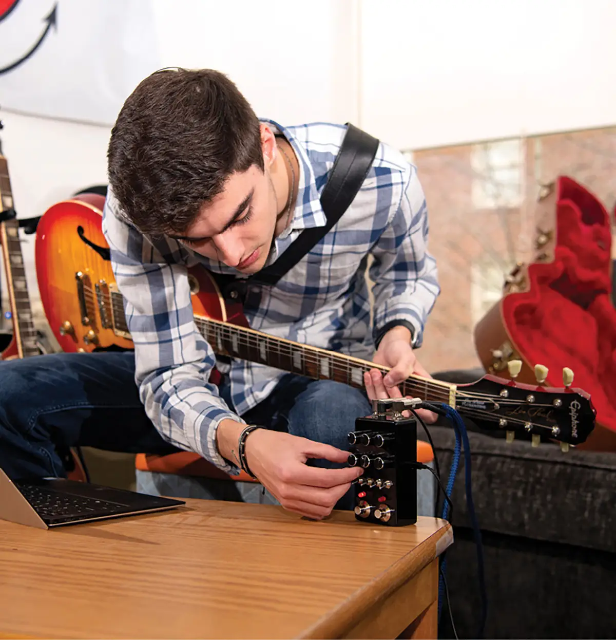 computer engineering major Thomas Smith with his custom-programmed guitar pedal