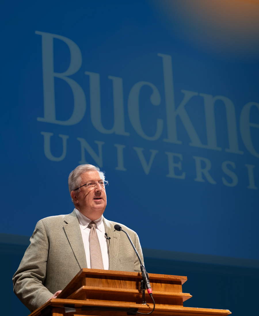 John C. Bravman standing at podium