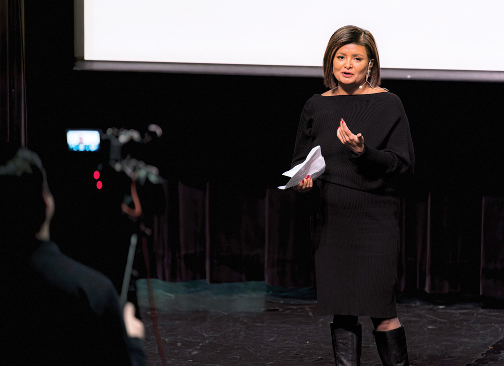 Joya Dass giving a speech on camera