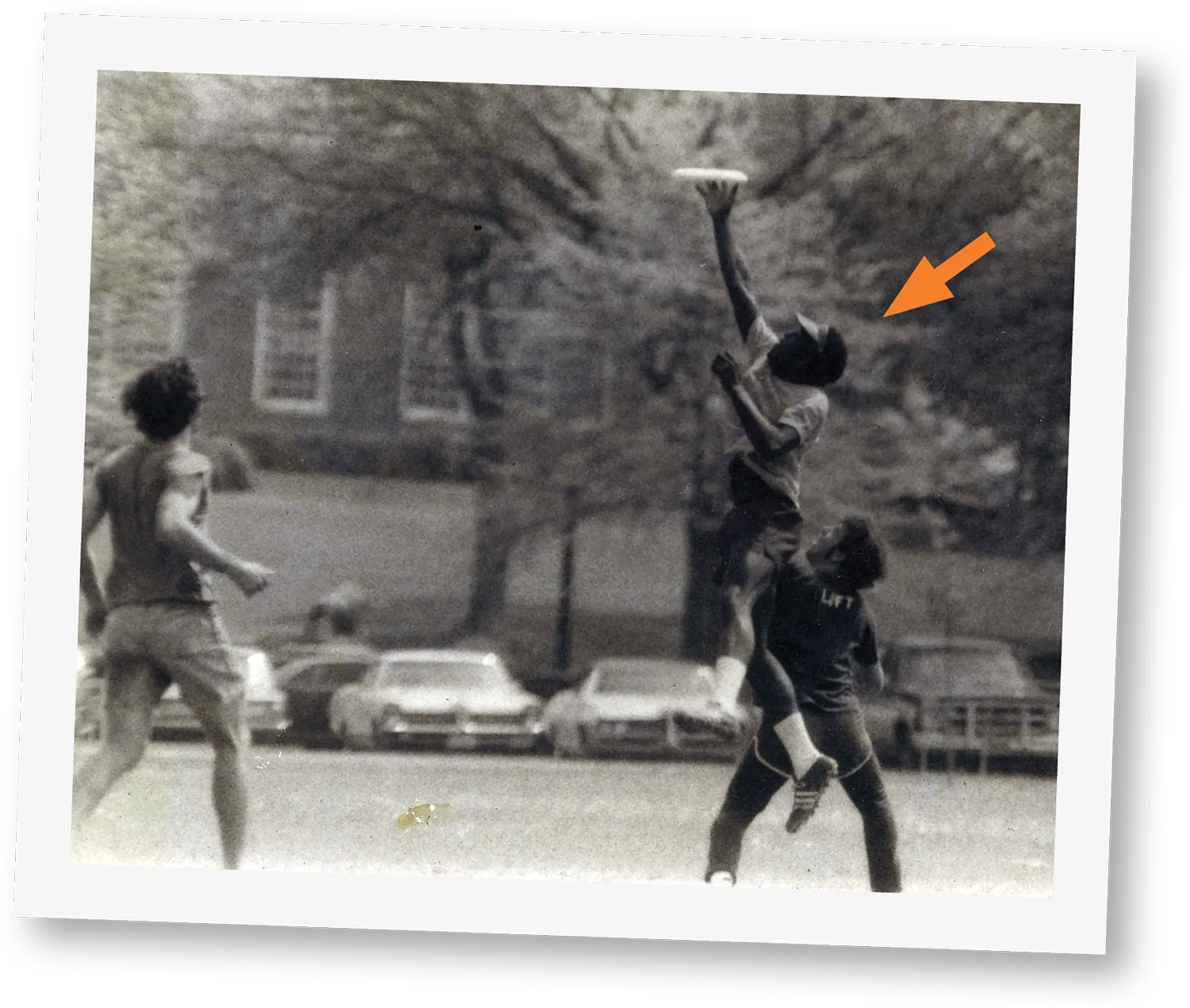 black and white polaroid of Bucknell students playing frisbee