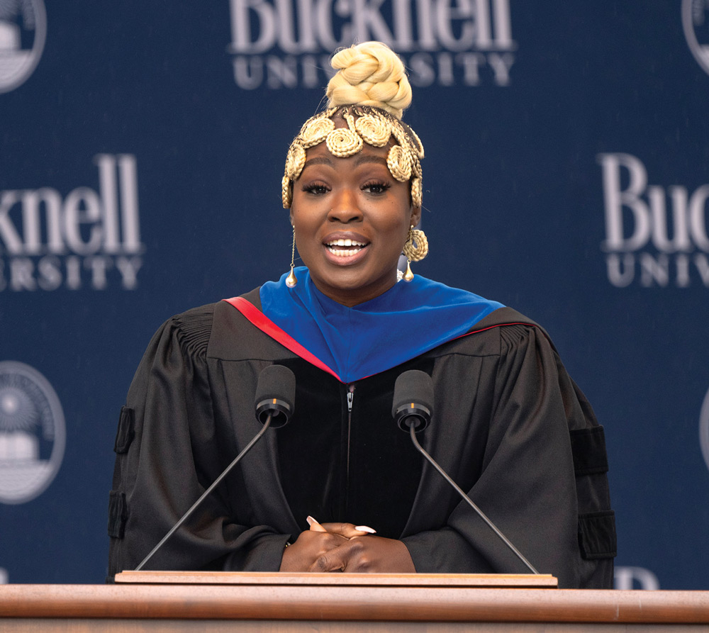 Nadia Sasso giving a speech at a podium with a Bucknell University backdrop behind her