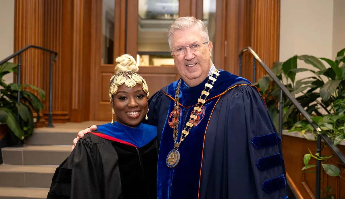 Nadia Sasso with John Bravman wearing graduation gowns