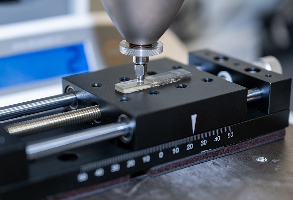 closeup of machine working on small piece of metal