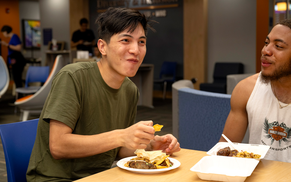 student smiling while eating