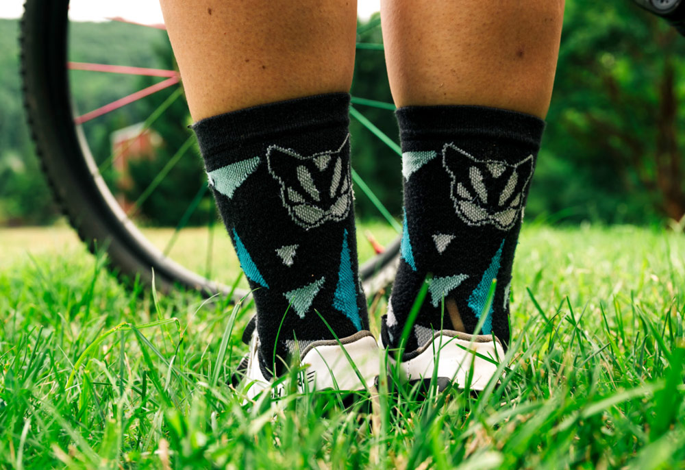 close up of the worn socks from the KellCat Devo’s race “kit” featuring the KellCat logo icon
