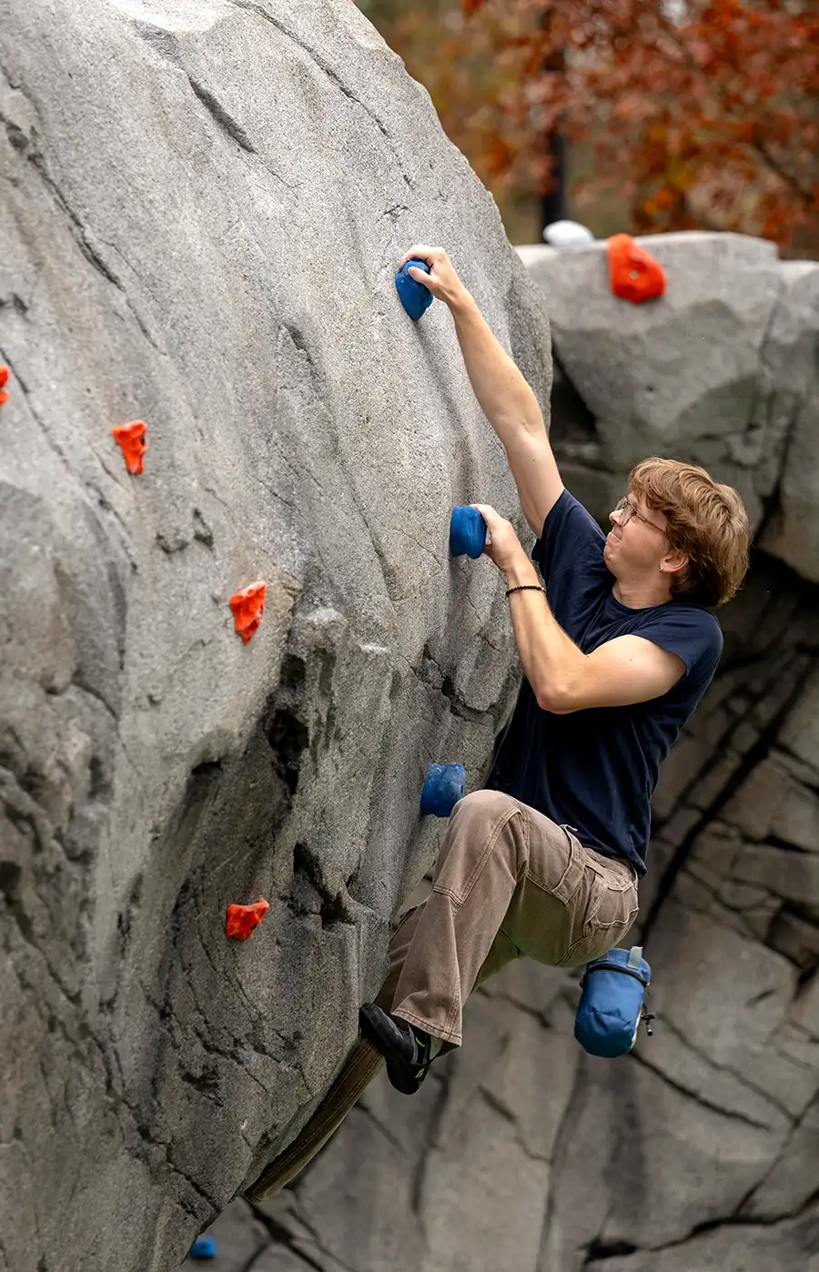 Douglas B. Hall ’91 Rock Climbing Memorial with a student climbing it