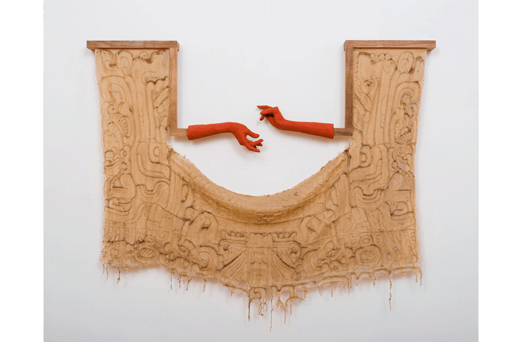 Textile sculpture with two hands with red gloves.