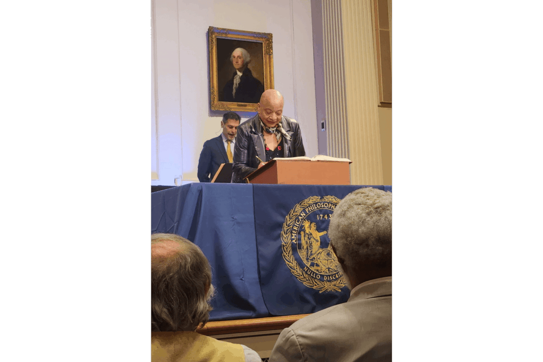 Color photograph of the artist at a podium.