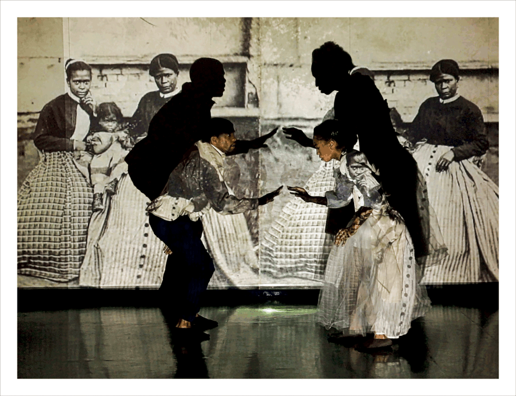 Color photograph of two dancers with projections.