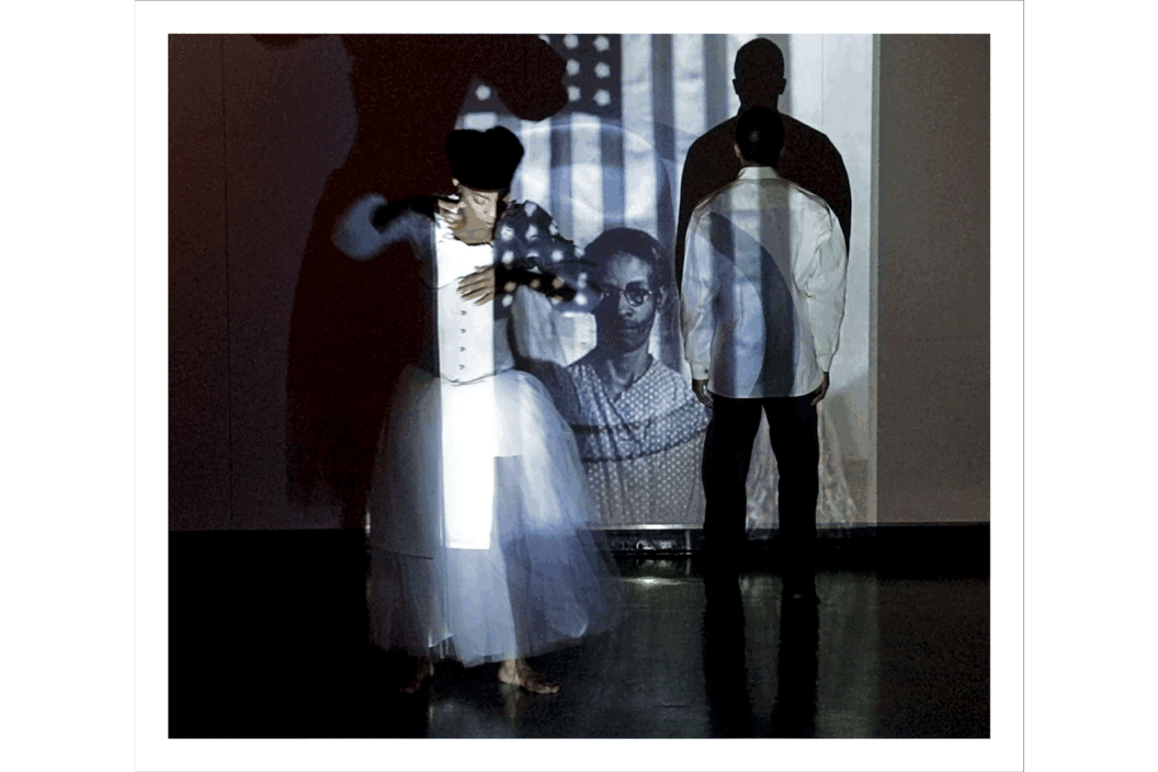 Color photograph of a dancer with a projection.