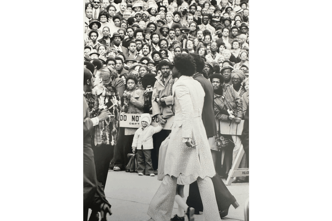 Black and white photograph of a crowd attending a funeral.
