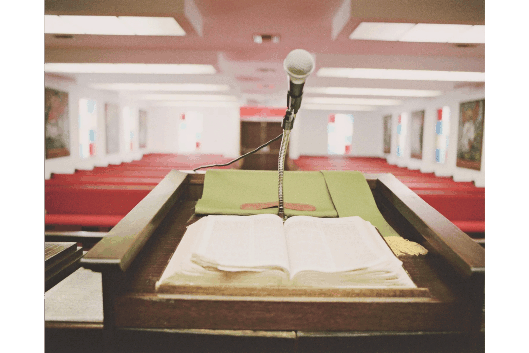 Color photograph from behind a pulpit.