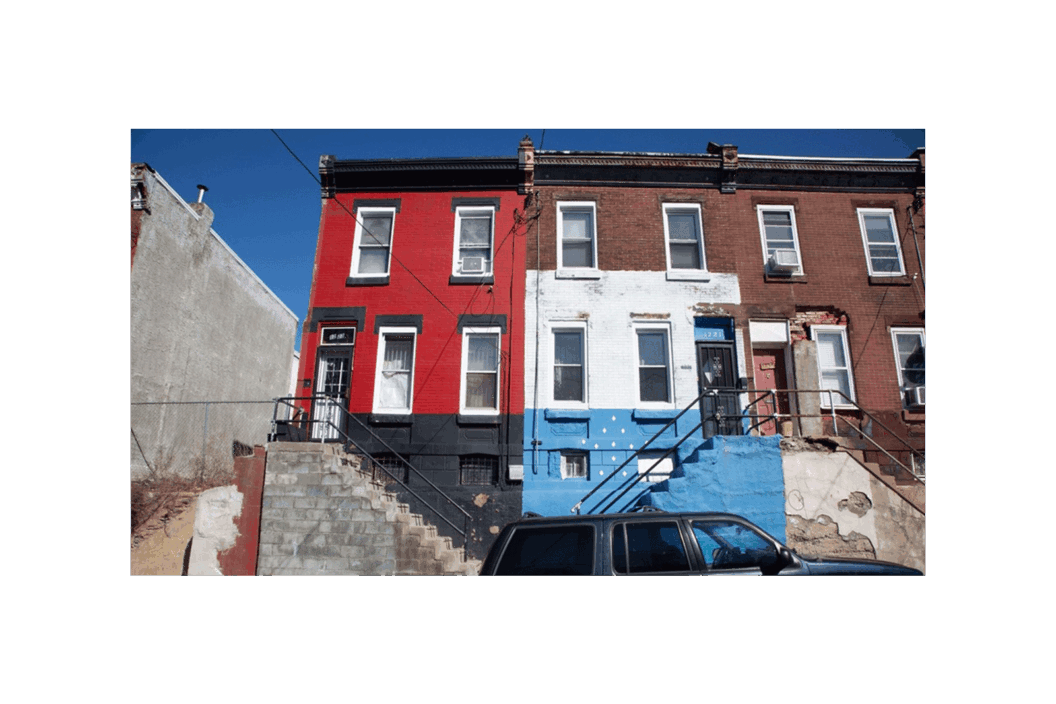 Color photograph of colorful homes on a street.