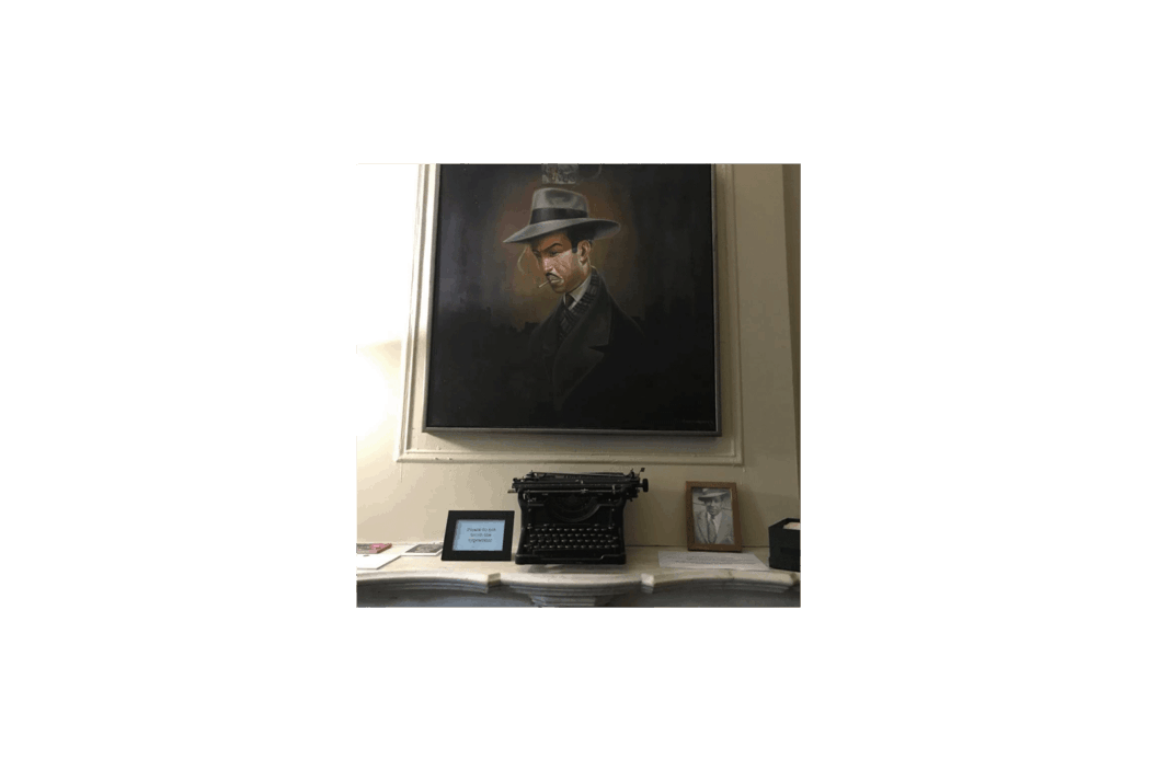 Color photograph of a portrait of Langston Hughes hanging on a wall.