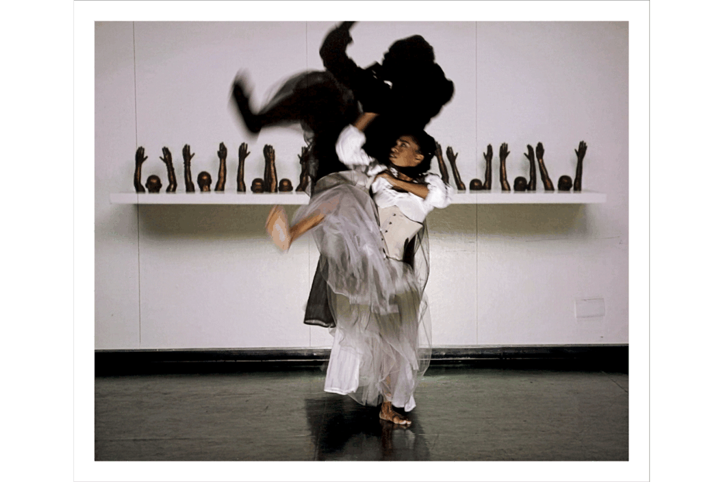 Color photograph of a dancer with a projection.