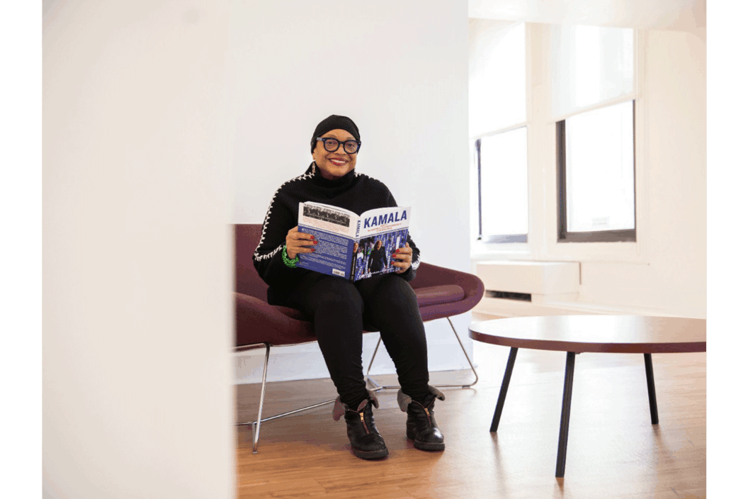 Color photo of the artist holding a book.