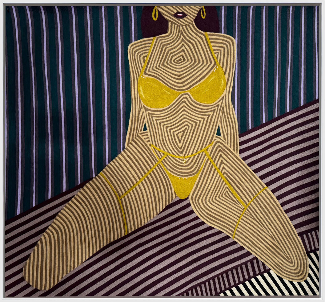 1600 A needlework featuring a woman in a yellow bikini sitting on the floor.