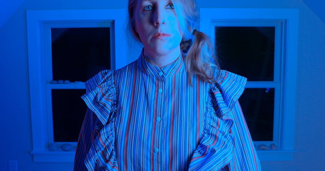 Portrait of Jasmine Dreame Wagner in a blue-lit room