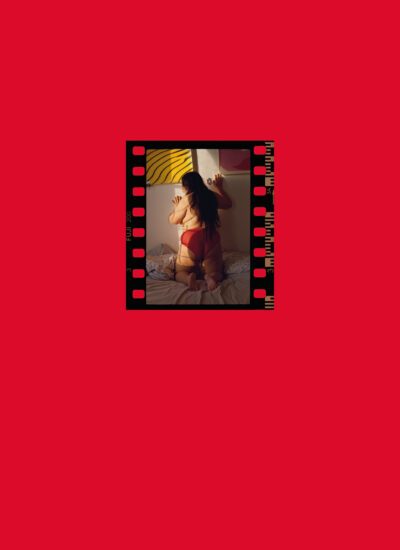 A red book cover with a small photograph of a woman on it but no words.