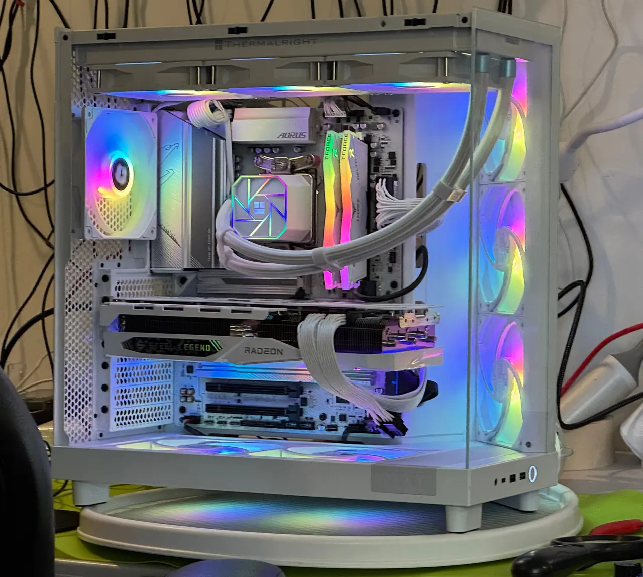 White custom gaming PC with lit fans and liquid cooling