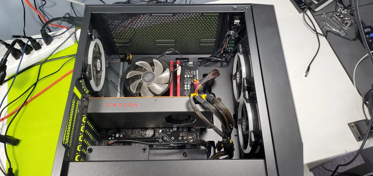 Desktop tower with the side panel off, graphics card and fans showing