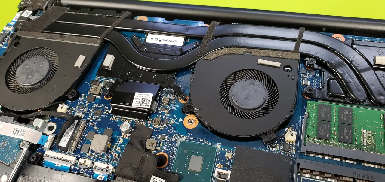 Laptop with the bottom cover off showing the fans and memory