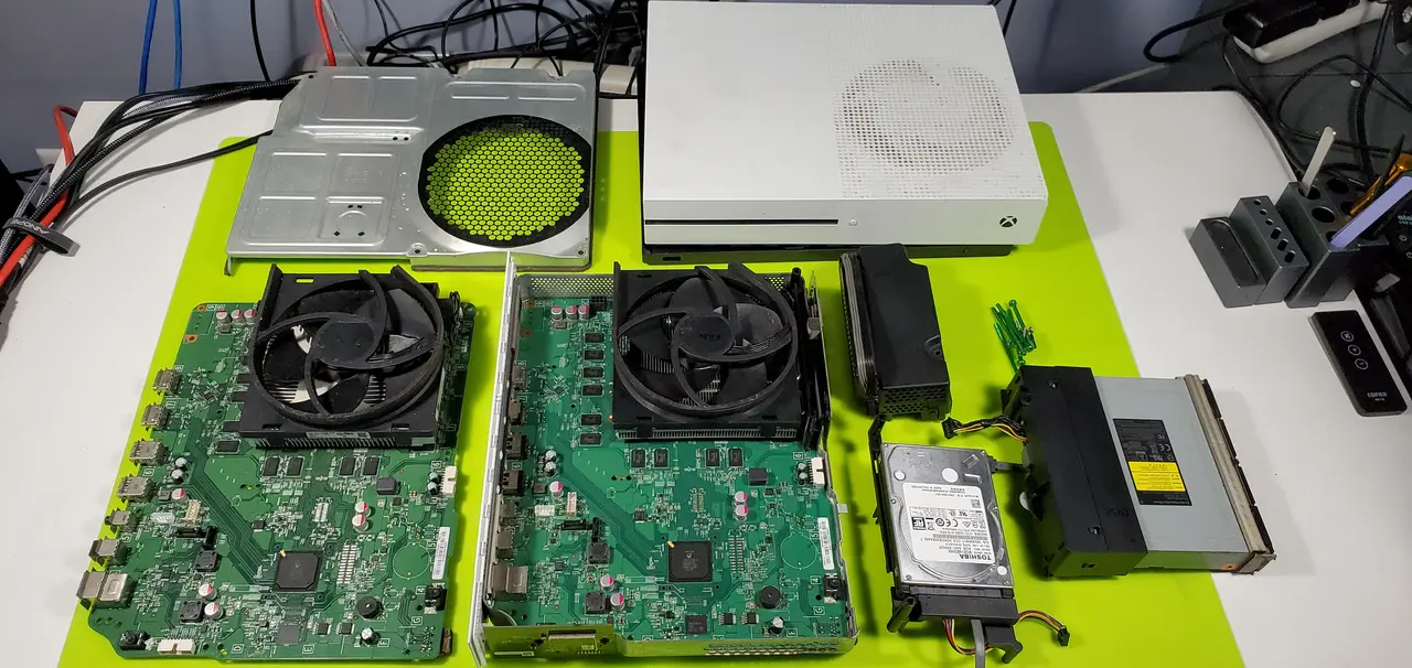 Xbox One S taken apart with the board and fan laid out