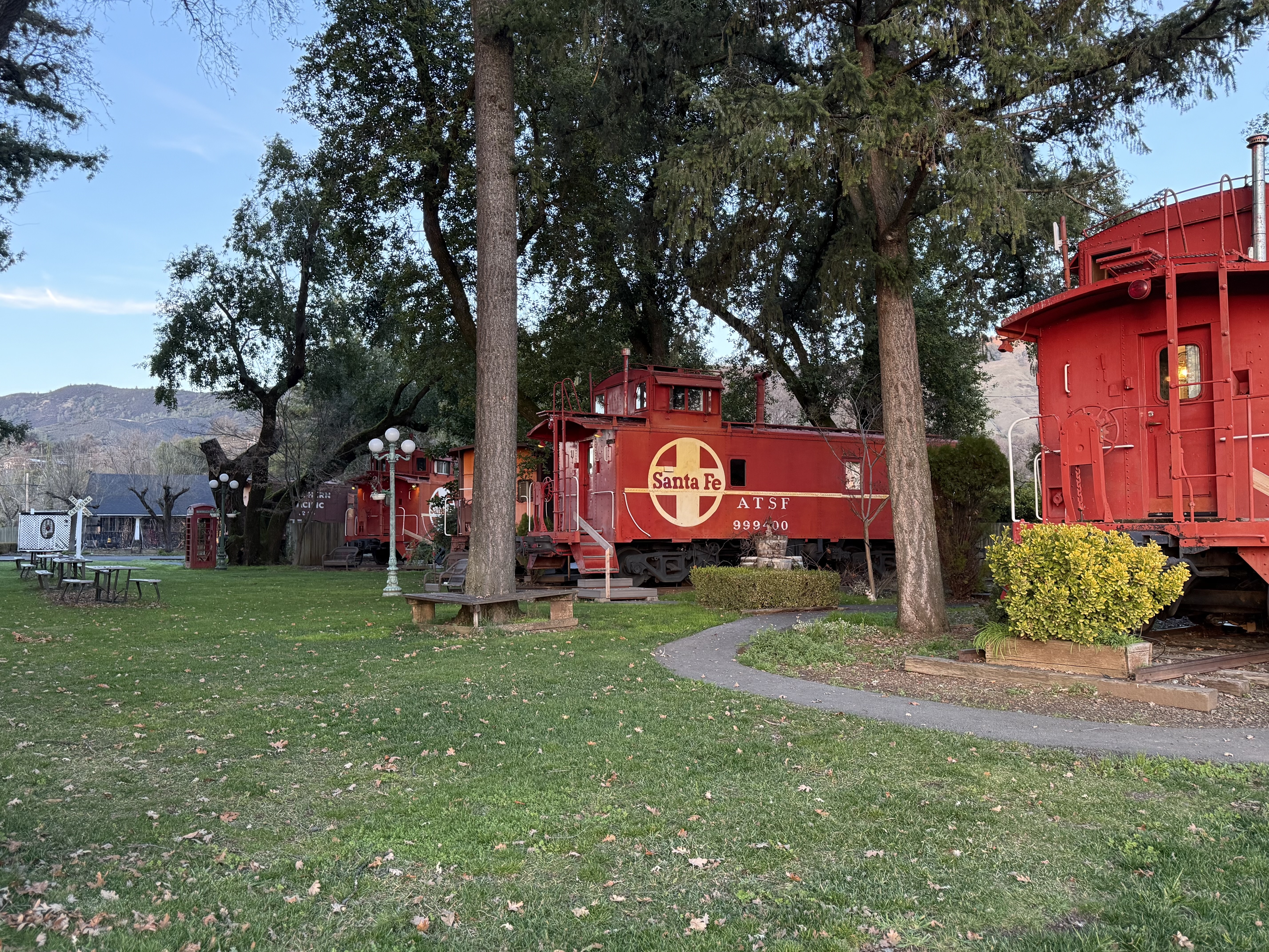a red train cars in a park