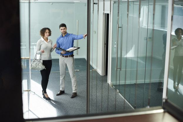 man and woman checking out a commercial real estate space