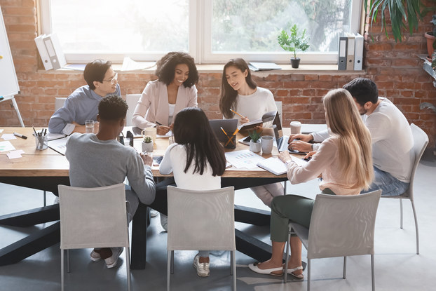 team of coworkers in a conference room for a meeting