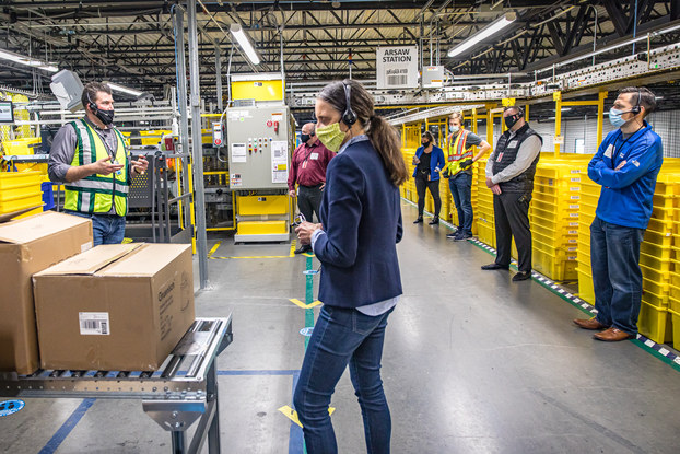 amazon employees working socially distanced in fulfillment center