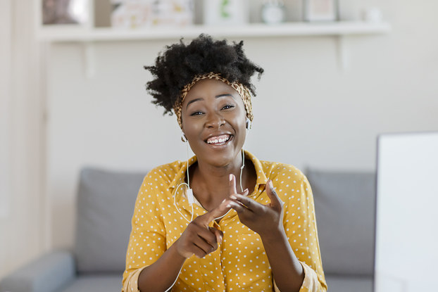 woman smiling while on a video chat.