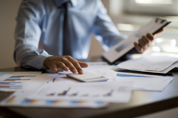 Businessman analyzes reports and data