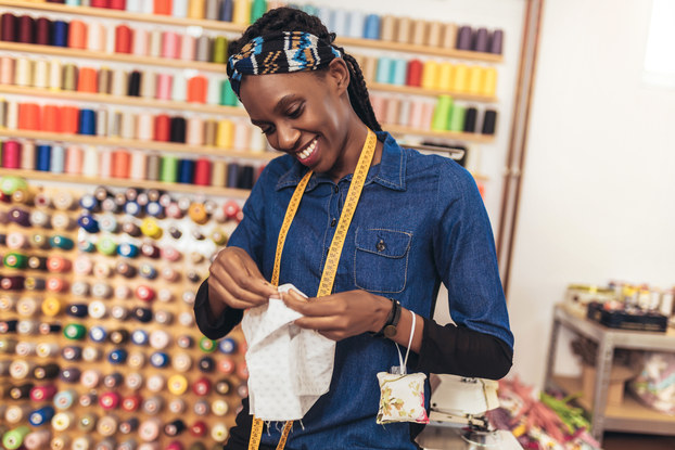Dress maker sews in her studio