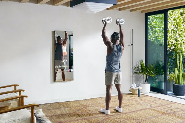 man working out in house with Mirror