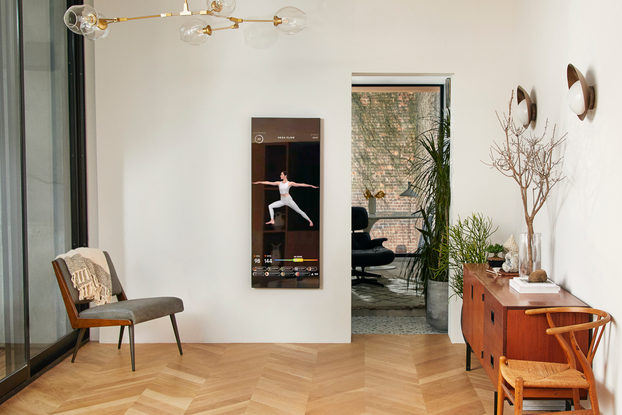 Fitness device Mirror hanging on wall inside a home.