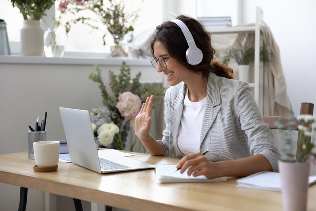 Woman greets virtual meeting attendees