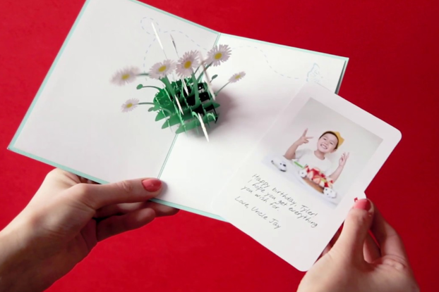 Person opening a greeting card from Lovepop.