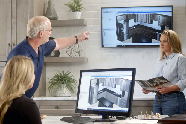 Customer and employees looking at screens at Home Outlet's Partner in Design Center.