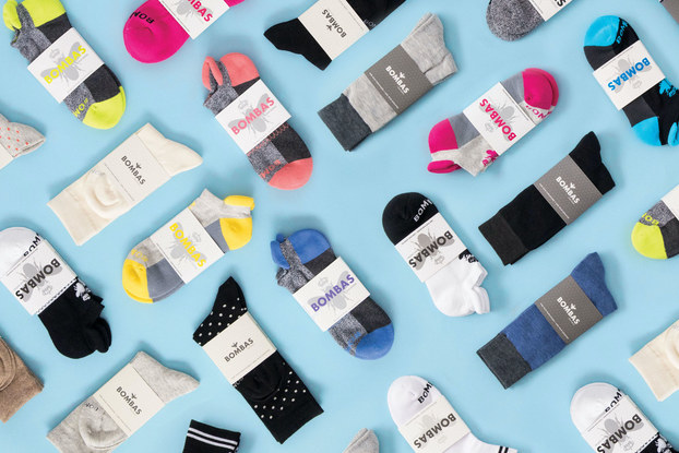 Bombas socks all spread out on a light blue background.