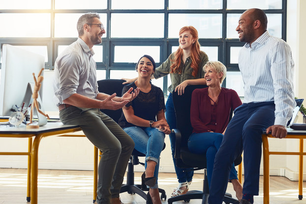 Business owner holds casual meeting with employees