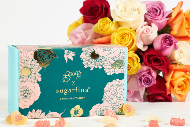 Flower arrangement by The Bouqs paired with a candy bento box from Sugarfina.