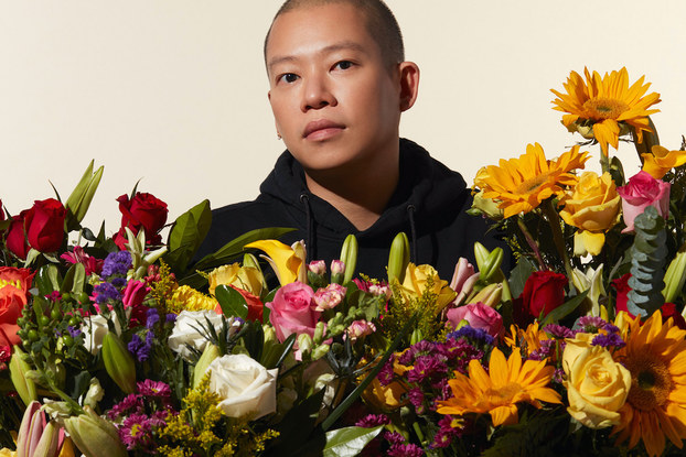 Fashion designer Jason Wu posing with flowers from 1-800-Flowers.
