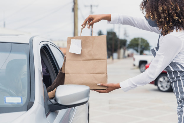 A customer picks up a purchase using curbside pickup.