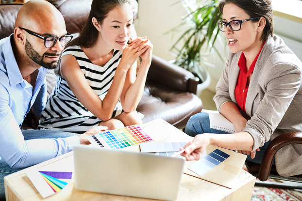 Business person presents design ideas to clients