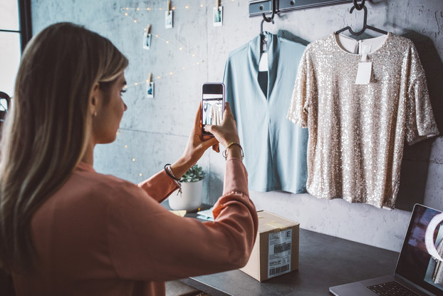 Small business owner taking photos of clothing for an online store.